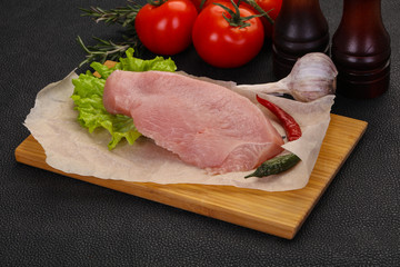 Raw Turkey steak served rosemary