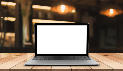 Laptop with blank screen on wooden table