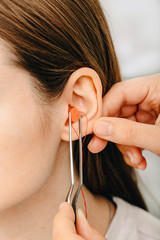 Process of making earplug from an impression of an individual s woman ear. Ear close-up. Personally...