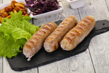 Grilled sausages served mushrooms and cabbage