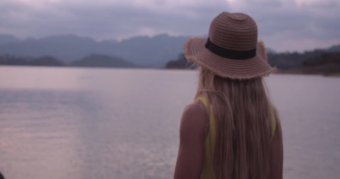 Blonde Female Tourist Admiring the Lakeside View in Thailand