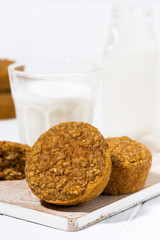 oatmeal pumpkin cakes and a glass of milk, vertical
