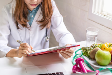 Nutritionist giving consultation to patient with healthy fruit and vegetable, Right nutrition and diet concept