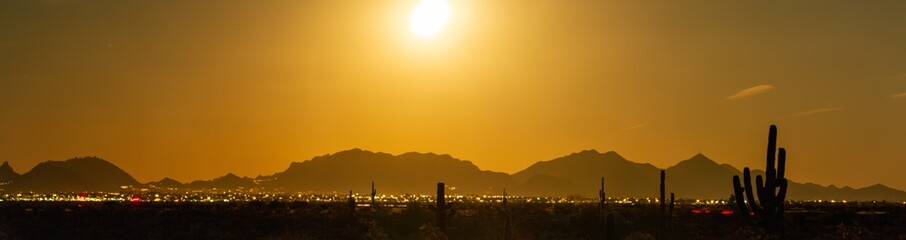 Naklejka premium Long exposure panorama of the full moon rising on the desert and city of Phoenix, Arizona.