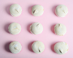 Nine vanilla marshmallows on a pink background
