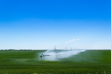 Farm water irrigation system sprays water on the field