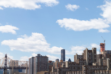 Fototapeta premium Midtown Manhattan Skyline with the Queensboro Bridge and a Beautiful Sky in New York City