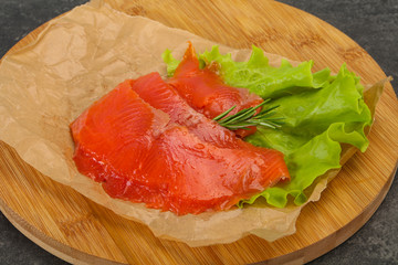 Sliced salmon fillet served rosemary