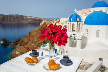 Morning coffee and croissants against the sea