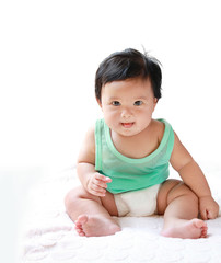 A Baby girl in the light blue dress Laughing happily and looking directly