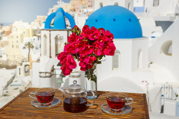 Morning tea  against the architecture of Santorini