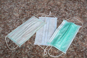 used surgical mask on the floor. discarded mask. The mask that was discarded after the virus spread.
