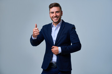 Close up portrait young man businessman. Caucasian guy business suit studio gray background.