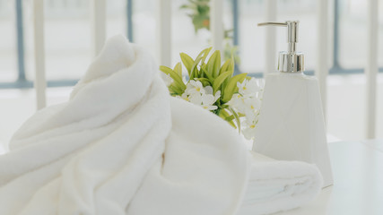 Fototapeta na wymiar Shampoo and shower cream bottle with towel