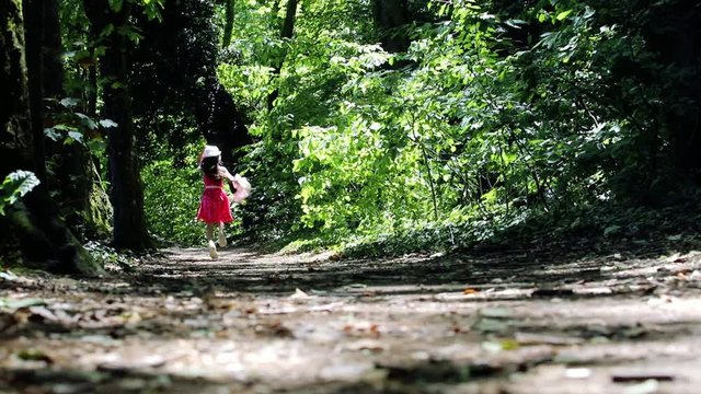 A little girl runs away in a forest