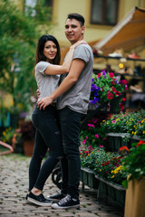 A couple in love slowly walks the streets of the city on a cool autumn morning.