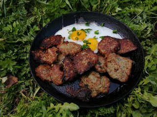 breakfast in a frying pan in nature fried eggs zalen meatballs potato pancakes potato pancakes meat beautiful