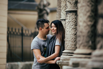 couple posing on the streets of a European city in summer weather.