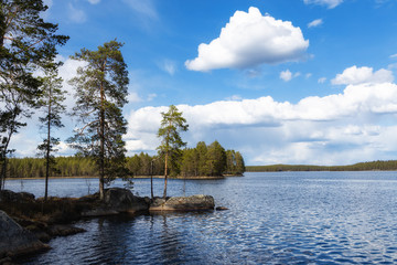 Beautiful lake at sunny day with clouds and blue sky in Helvetinjarvi National park, Finland 