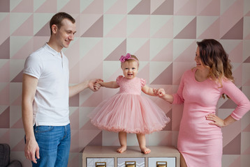 Portrait of a young happy family with the kid at home