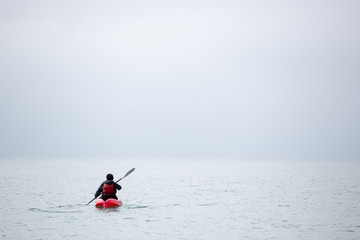 Fototapeta na wymiar Sea kayaker paddling out to sea