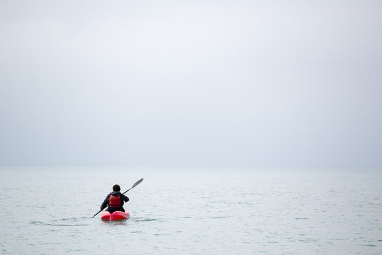 Sea Kayaker Paddling Out To Sea