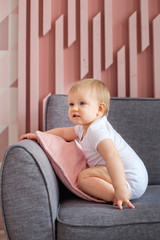 Fototapeta premium a frightened child on the edge of the sofa