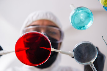 Young male chemist working in the lab