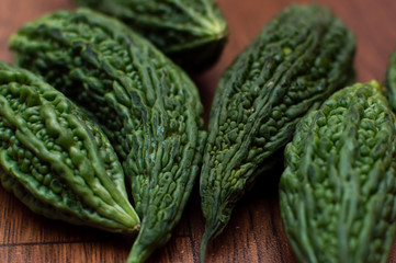 Bitter melons placed on a brown wooden floor