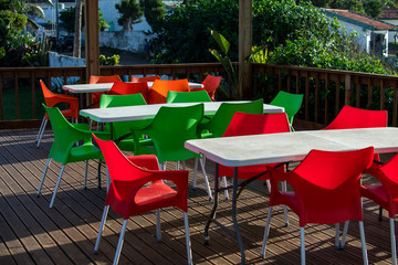 red plastic chairs on the terrace with sea view