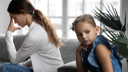 Fototapeta na wymiar Stubborn young Caucasian mother and little preschooler daughter ignore avoid talking after family fight, hurt offended mom and girl child feel mad upset, misunderstanding, generation gap concept