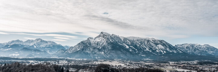 Fototapeta na wymiar Panoramic aerial drone shot view of Austrian Alps snowy untersberg