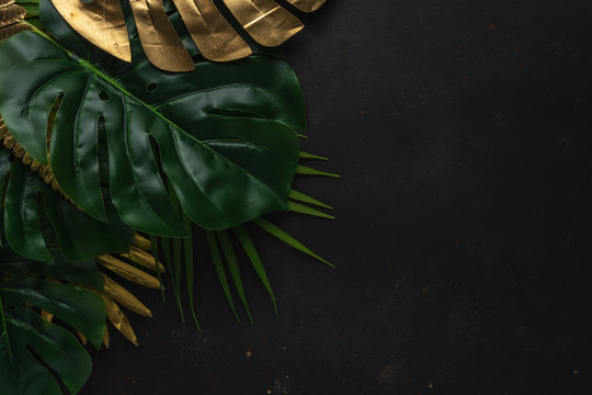 Creative Layout With Gold And Green Tropical Palm Leaves On Black Background. Minimal Summer Abstract Pattern.