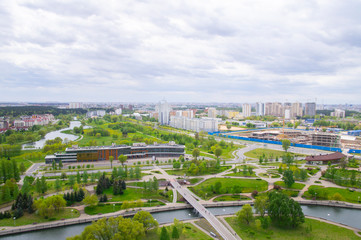 Fototapeta na wymiar Top view of the city landscape. Buildings and roads in summer. 24 May 2020. Minsk. Belarus