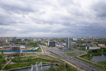 Fototapeta premium Top view of the city landscape. Buildings and roads in summer. 24 May 2020. Minsk. Belarus
