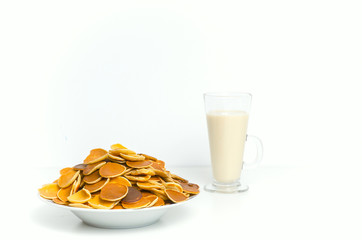 Trendy pancake cereal meal with milk. Tiny baked pancakes. Breakfast food. Mini pancakes. 