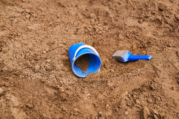 children's bucket and scoop are forgotten in the sandbox