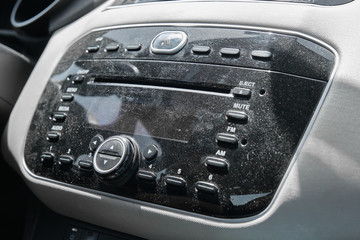 Dusty, uncleaned car radio closeup © ozencdeniz