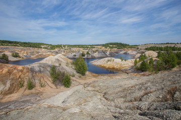 Amazing kaolin clay marsian landscape quarry open pit at summer day