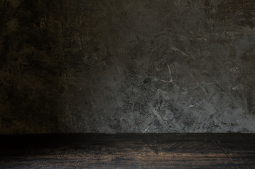 Old wood table on dark background.