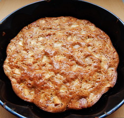 Apple pie in a baking dish on the table
