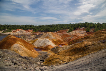 Obraz premium Amazing kaolin clay marsian landscape quarry open pit at summer day
