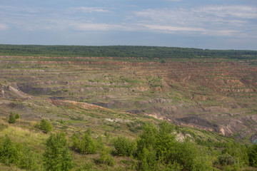 Fototapeta na wymiar Abandoned coal ore quarry open pit