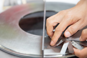 Instrument technician measuring flatness of orifice plate by using filler gauge for inspect the...