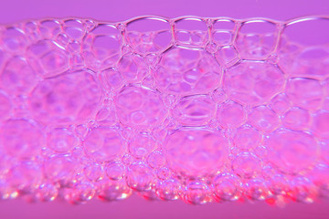 Blurred background with pink drink line and bubbles in high magnification.