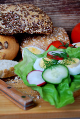 sandwich with lettuce, ham and boiled egg rings, radish and dill