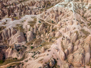 Aerial view of Goreme National Park, Tarihi Milli Parki, Turkey. The typical rock formations of Cappadocia with fairy chimneys and desert landscape. Travel destinations, holidays and adventure