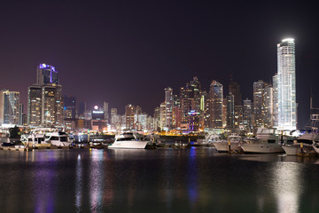Fototapeta na wymiar night Cityscape from across the bay in Panama with a serene reflection on the water. 