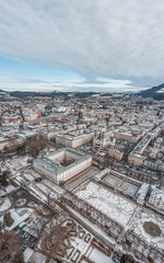 Fototapeta premium Aerial drone shot view of Mirabell Palace in Salzburg coverd with snow in winter time