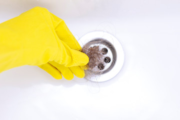 Dirty fallen hair in a gloved hand. House cleaning in the bathroom. Hair in the sink. Hair in the...